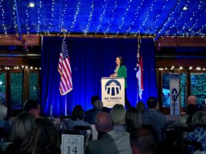 Katy Faust speaking at the Angus Barn Pavilion during NC Family's Raleigh dinner