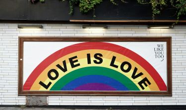 Rainbow sign with "love is love" quote