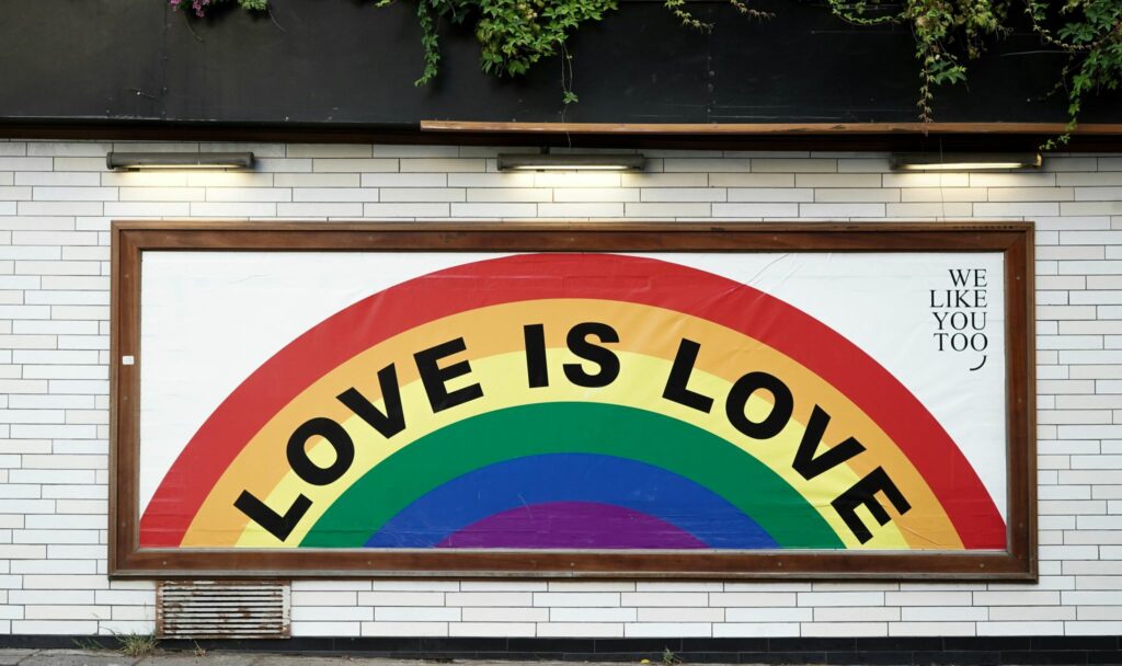 Rainbow sign with "love is love" quote