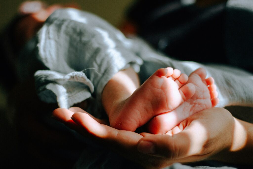 Newborn baby being held