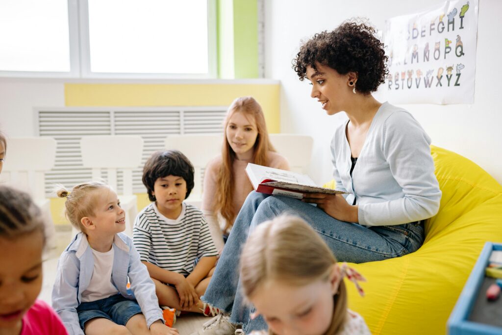 Children reading a book together in a classroom