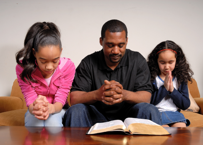 Family Praying at a table