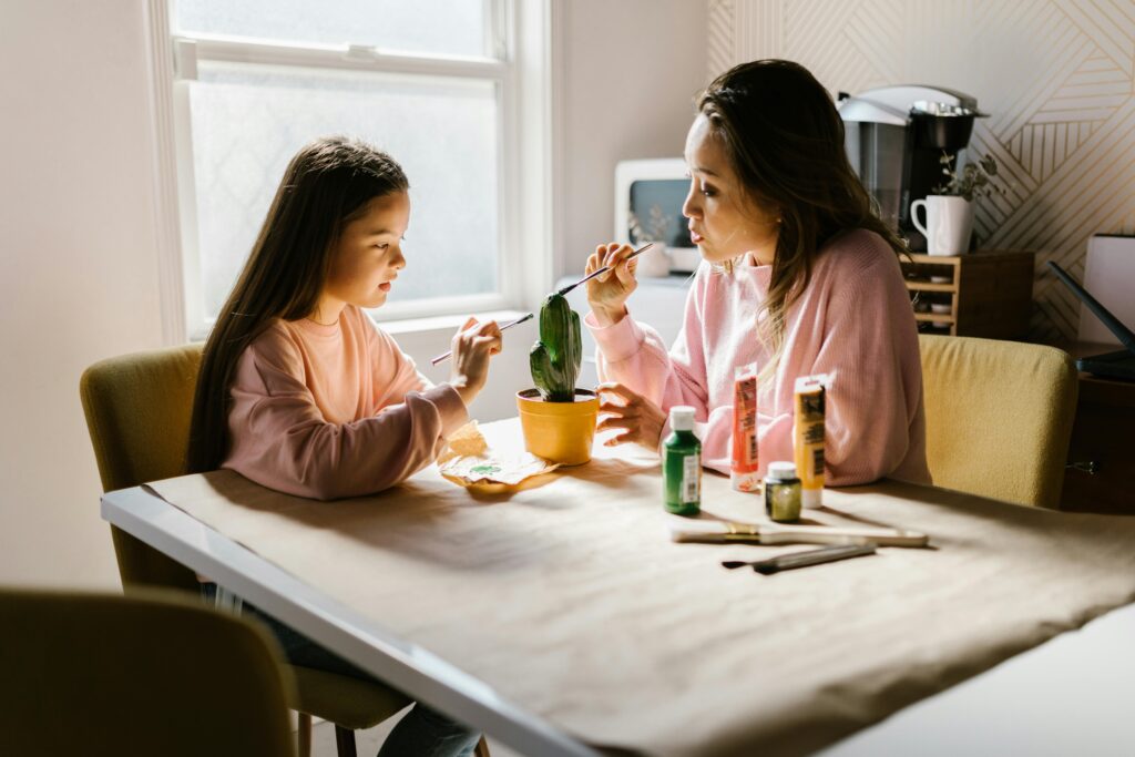 Mother and daughter painting together