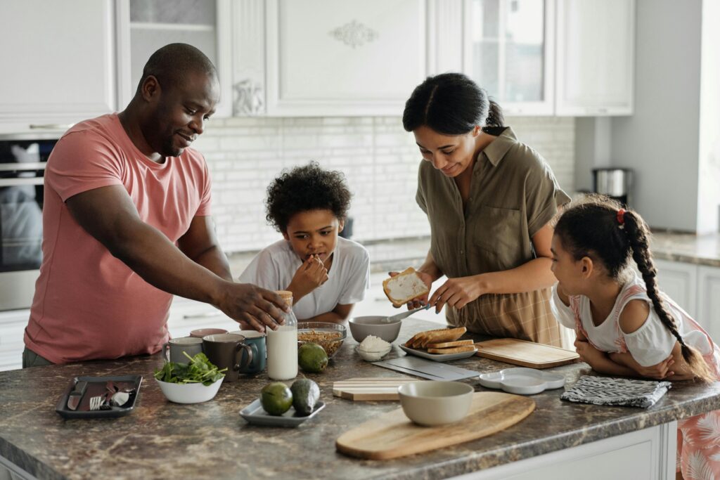 Family of four cooking in a kitchen